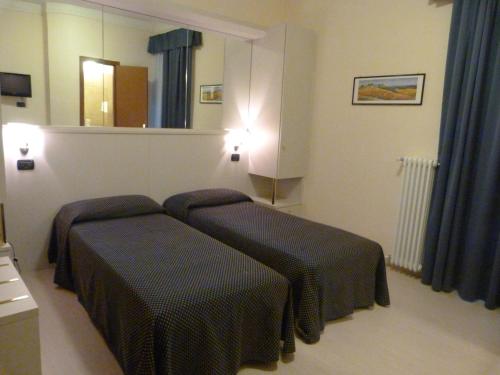 Кровать или кровати в номере Hotel Aurora