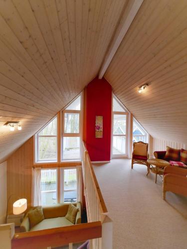 a living room with a large ceiling with windows at Ferienpark Bad Saarow in Bad Saarow