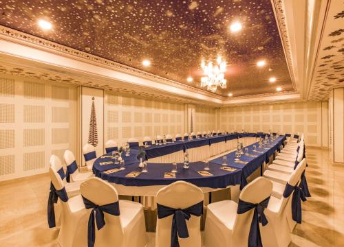 a large banquet hall with a long table and chairs at Umaid Haveli-A Heritage Style Hotel & Resort in Jaipur