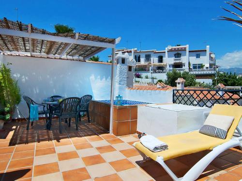 a patio with a table and chairs on a roof at Holiday Home Amanda by Interhome in Nerja