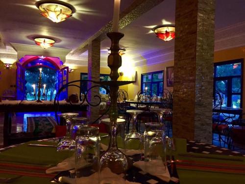 a restaurant with a table with glasses on it at Camping & Hôtel Le Calme in Essaouira