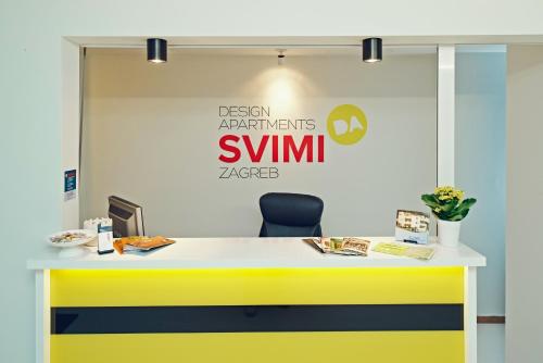 a yellow and white desk with a chair in an office at Design Studios SVI-MI in Zagreb