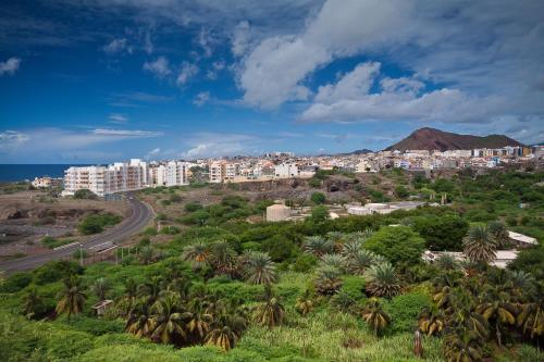 a city with palm trees and a road at Aparthotel Praiano in Praia
