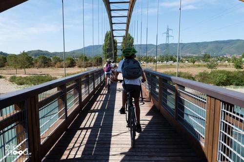 a group of people riding bikes on a bridge at Camping Village Mugello Verde in San Piero a Sieve