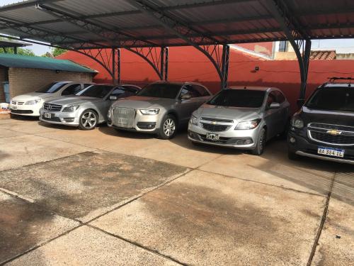 a group of cars parked in a parking lot at Hotel Las Residentas in Luque