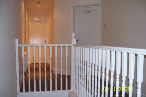 a room with a staircase with a white door at Citystay Hotel in London