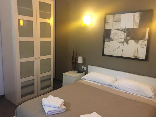 a bedroom with a bed with two towels on it at Almi Rooms in Rome