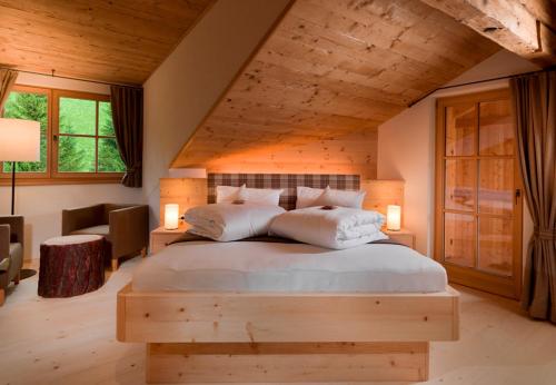a bedroom with a large bed in a attic at Bruggerhof Prags in Braies