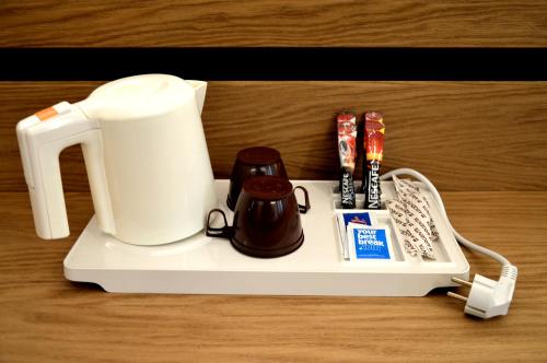 a tray with a coffee maker and other items on it at Best Western Plus Soave Hotel in San Bonifacio