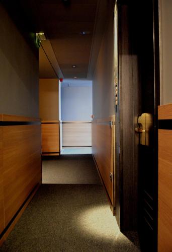 an empty room with a closet with a refrigerator at Best Western Plus Soave Hotel in San Bonifacio