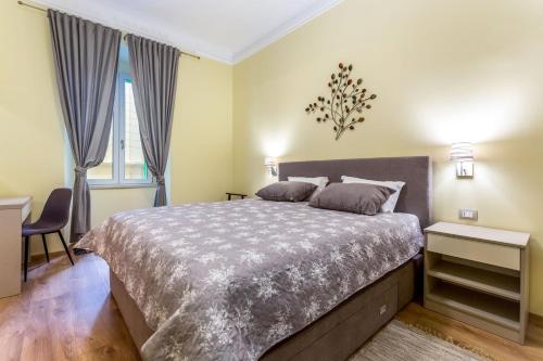 a bedroom with a large bed and two windows at Casa Veneziana in Rijeka