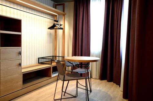a room with a table and a chair and a desk at Best Western Plus Soave Hotel in San Bonifacio