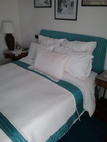 a large bed with white pillows on top of it at Stella in Quartu SantʼElena