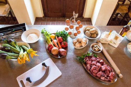 a table with plates of food and bowls of vegetables at Fattoria Fibbiano in Terricciola