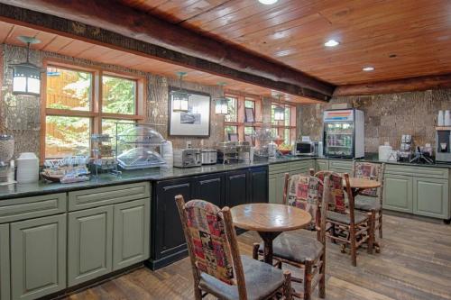 a kitchen with a table, chairs and a refrigerator at Old Creek Lodge in Gatlinburg