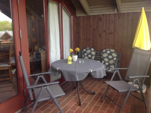 einen Tisch und Stühle auf der Veranda eines Hauses in der Unterkunft Ferienwohnung Michel in Glücksburg