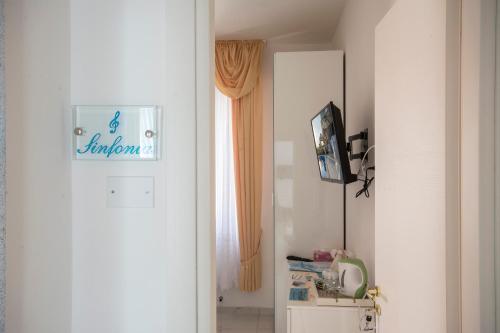 a room with a door to a room with a refrigerator at Villa Armonia in Praia a Mare