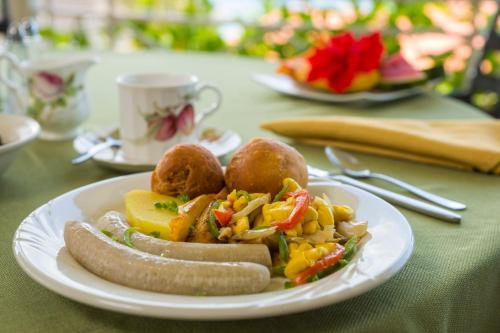 a plate of food on a table at Polkerris Bed & Breakfast in Montego Bay