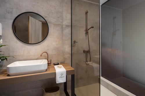 a bathroom with a sink and a shower at San Servolo Wellness Resort - Adults Only in Buje