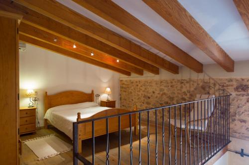 a bedroom with a bed and a staircase at Can Olivera in Llubí