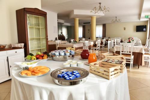 a table with food on it in a restaurant at Hotel Victoria in Torre Santa Sabina
