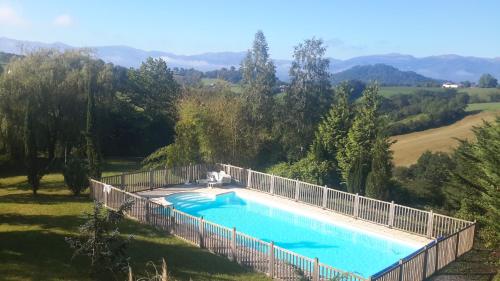 a large swimming pool with a fence around it at Harkurutxea in Jaxu