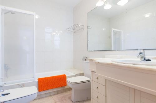y baño con aseo, lavabo y espejo. en Mollet, en Puerto de Alcudia