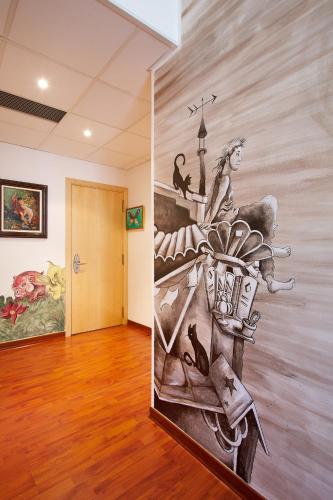 a mural on the wall of a room with a hallway at Hotel Plaza Inn in Figueres
