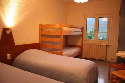 a bedroom with two bunk beds and a window at Le Collet d'Auron in Auron