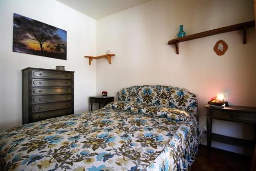 a bedroom with a bed and a dresser at Casa Soleil by Holiday World in Limone Piemonte