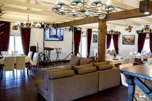 a living room with a couch and tables and chairs at "Дальний кордон" in Moshchanytsya