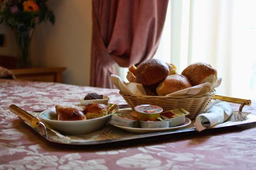 a tray with a basket of pastries on a table at Hotel Savoia Sorrento in Sorrento