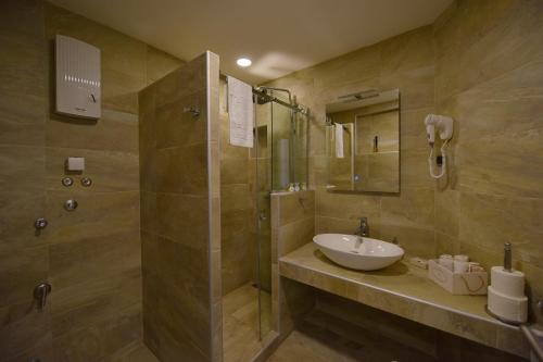 a bathroom with a sink and a shower at Apartman Centar Bg in Belgrade