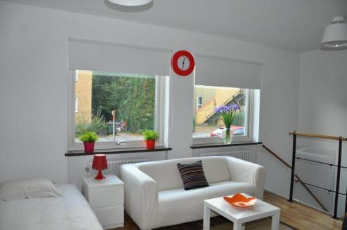 a living room with a white couch and a window at VillaVega Apartments in Lund