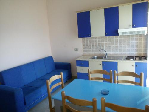 a living room with a blue couch and a table at Eleart in Golem