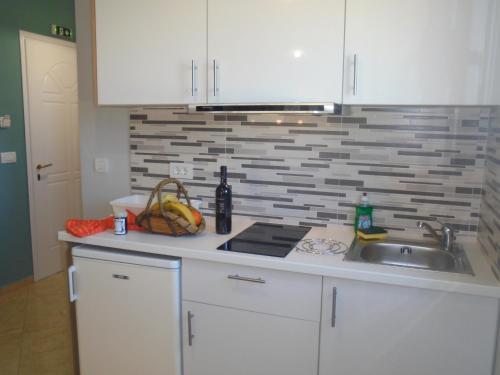 a kitchen with a sink and a counter top at Ourania Studios in Sami