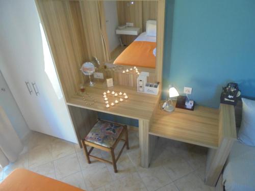 a bedroom with a dressing table and a mirror at Ourania Studios in Sami