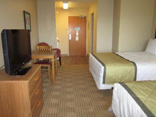 a hotel room with two beds and a flat screen tv at Extended Stay America Select Suites - Austin - Round Rock - North in Round Rock