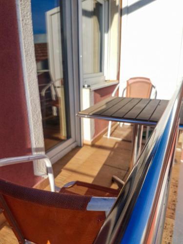 a balcony with two tables and a window at Smještaj Natalija in Osijek