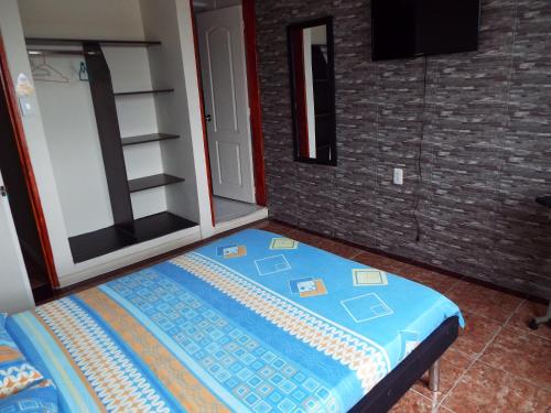 Postel nebo postele na pokoji v ubytování HotelIam Armenia - Encanto y descanso en el corazon del Quindio