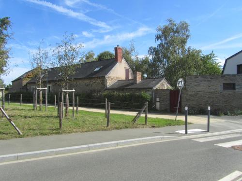 an old building with wooden poles on the side of a street at La Petite Charnasserie in Angers