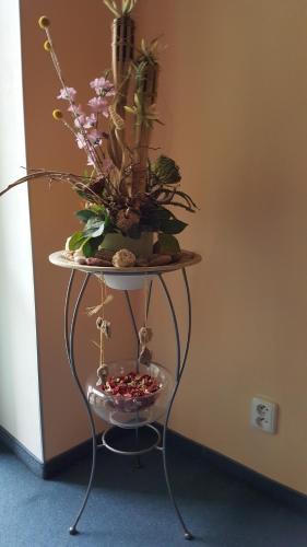 a table with flowers and plants on top of it at Penzion PIANO & Apartment Sokolov in Sokolov