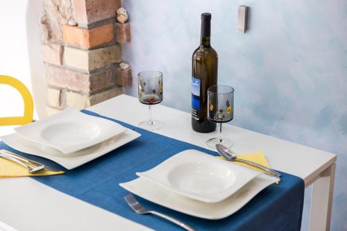 a table with two glasses and a bottle of wine at Apartments Linda in Mošćenička Draga