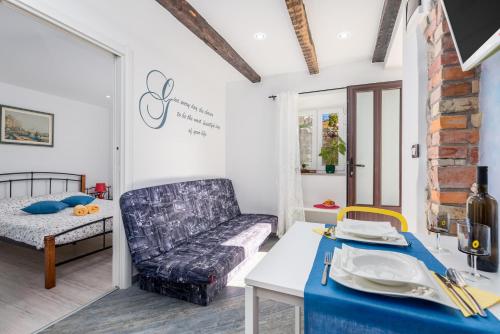 a living room with a couch and a table at Apartments Linda in Mošćenička Draga