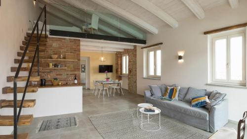 a living room with a couch and a table at Casa Visette in Monforte dʼAlba