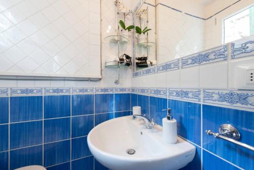 uma casa de banho azul e branca com um lavatório e um WC em Love weekend near Piazza Ognissanti em Florença