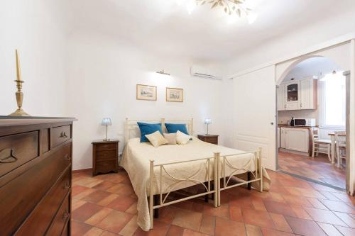 a bedroom with a bed with blue pillows on it at Love weekend near Piazza Ognissanti in Florence