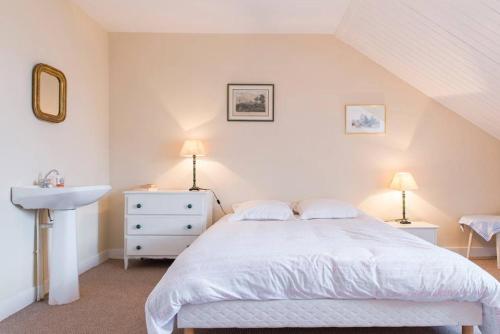 a bedroom with a white bed and a sink at Chambres Saint Donatien in Nantes