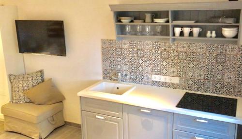 a bathroom with a sink and a bench in it at Landhaus Schlunt in Wustrow