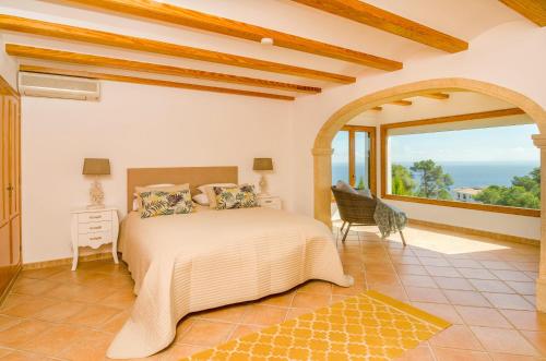 a bedroom with a bed and a large window at Villa Miramar, Luxury Villa Rental - Javea in Balcon del Mar